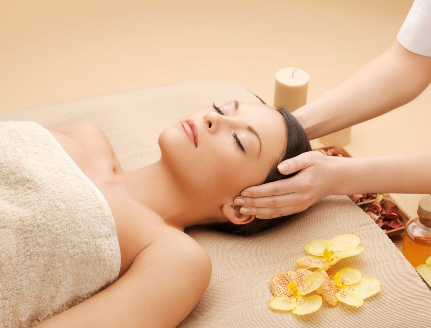 A woman getting her head washed by a masseuse.