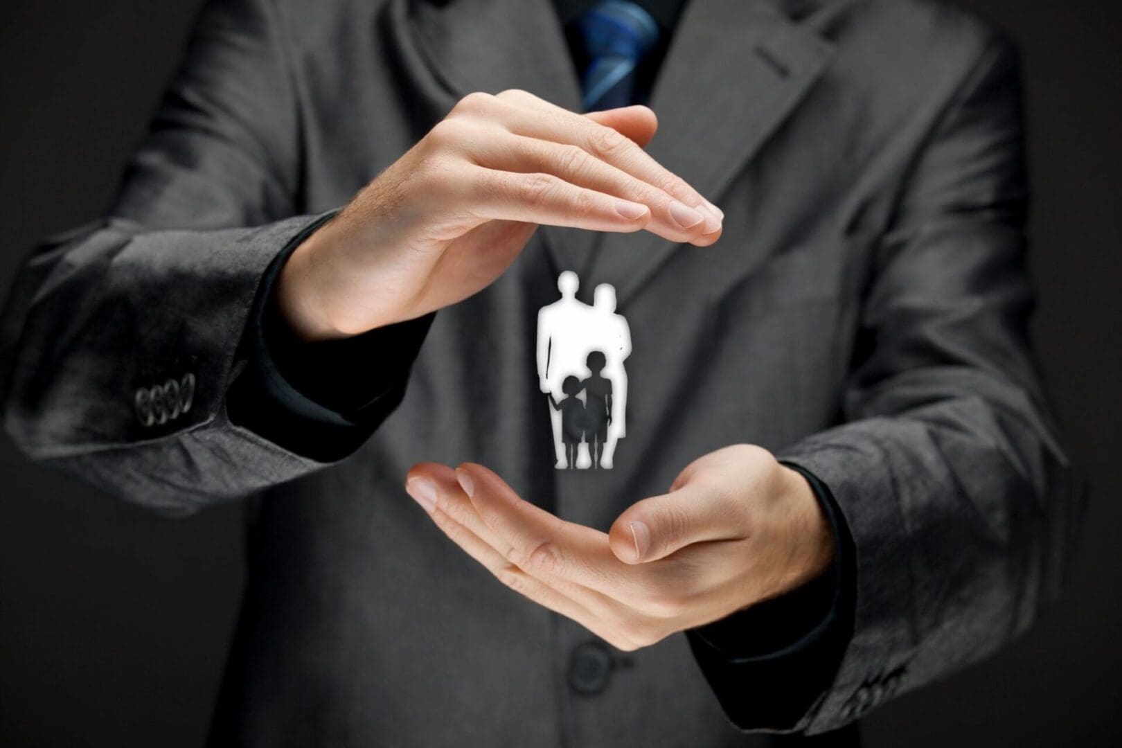 A man in suit and tie holding out his hands.